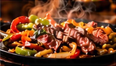 Steak fajitas on a sizzling platter